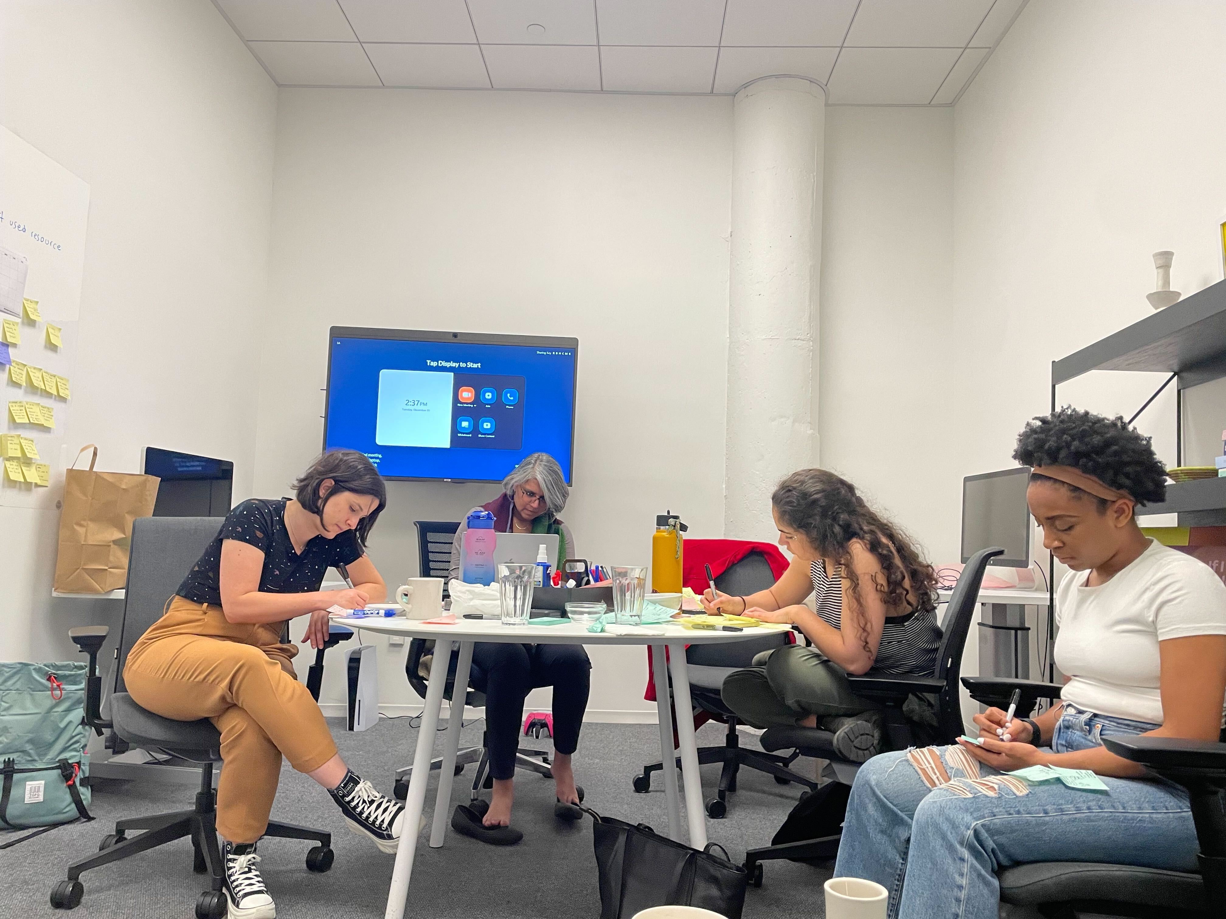 The project team sketching concepts on sticky notes during a working session